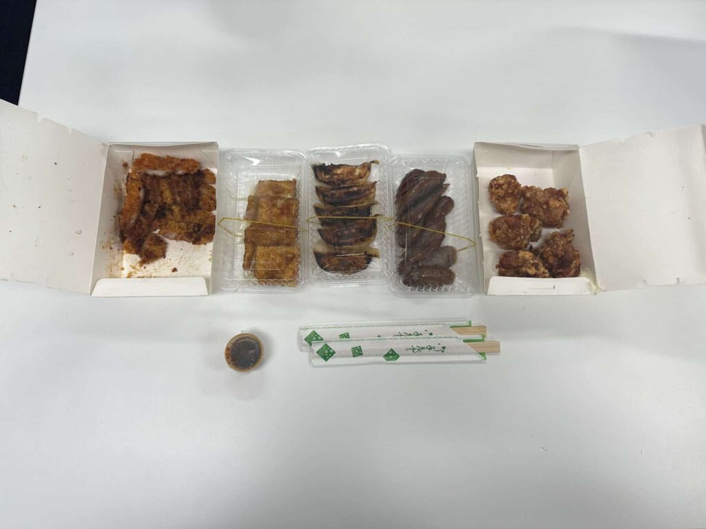 Ordered meals from left to right are Katsu, Teriyaki Tofu, Pork Gyoza, Osaka Sausage, and Tatsuta Age