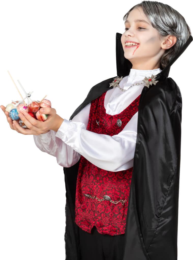 a woman dressed in a vampire costume holding a toy