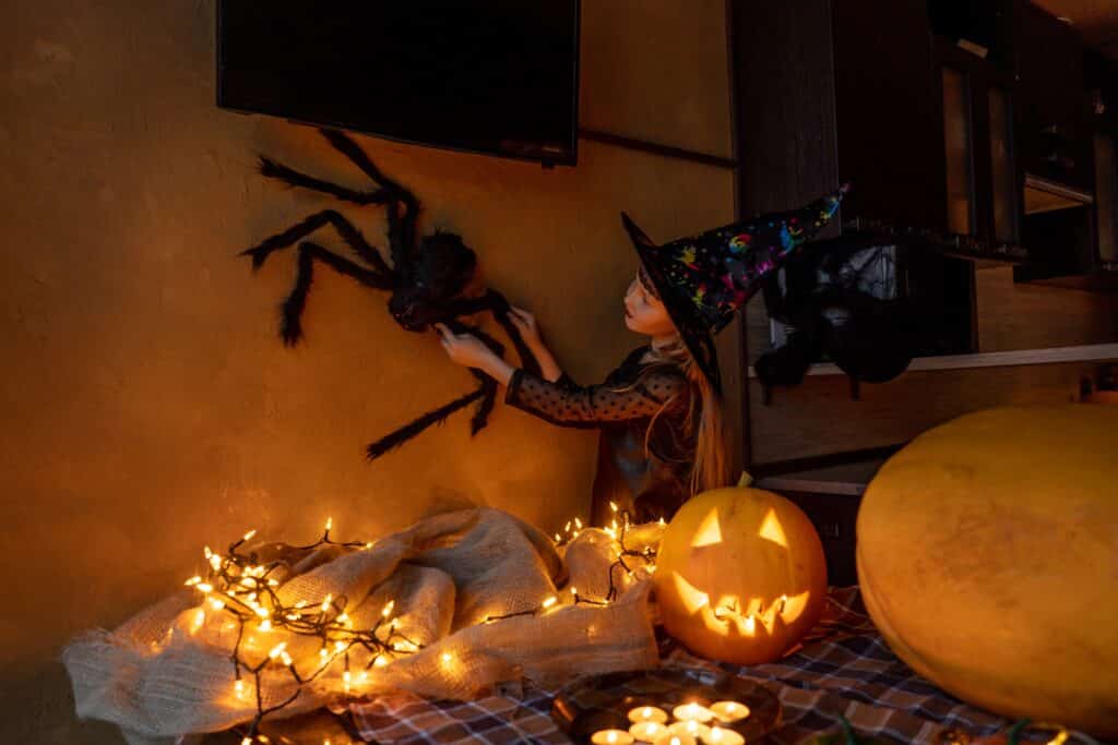 a child girl prepares to celebrate halloween in witch costume