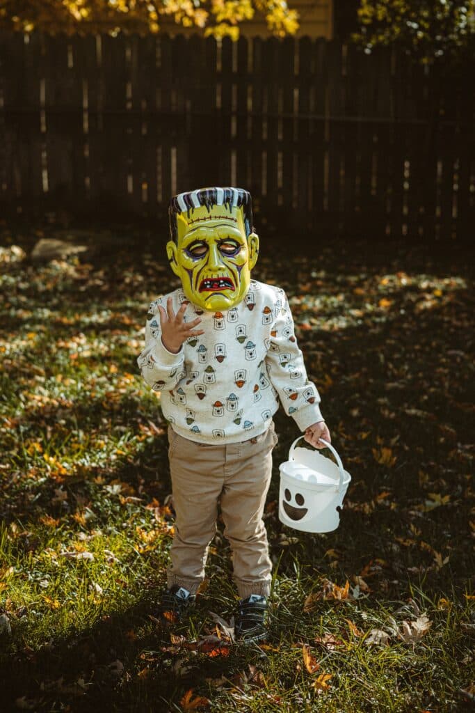 child wearing Frankenstein mask