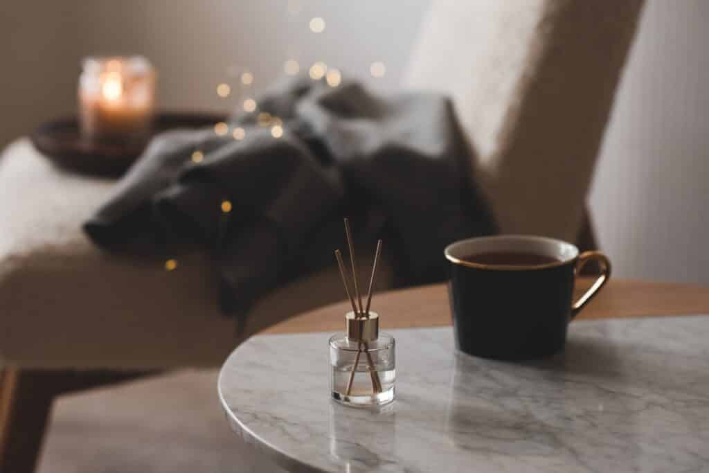 cozy hygge atmosphere with cup of tea and fragance