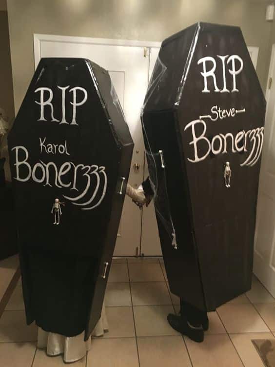 Two people dressed in creepy coffin costumes