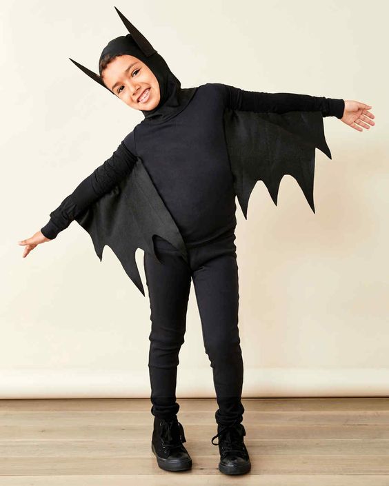 a little boy in spooky bat costume