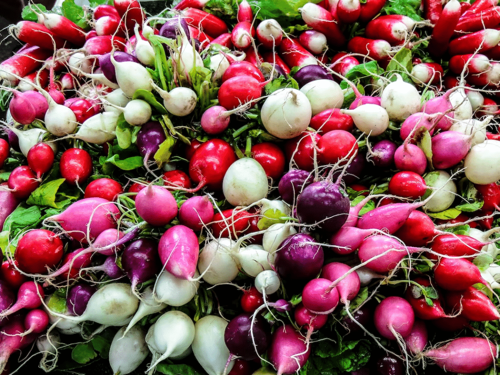 radishes on display at a market.